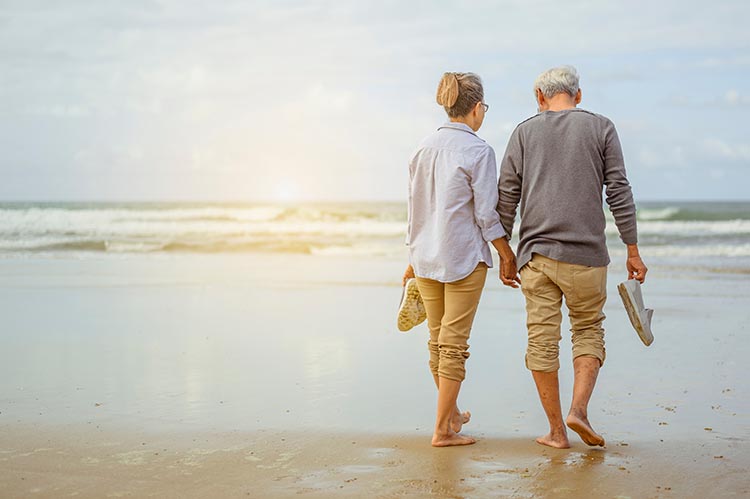 Senior couple walking on the beach holding hands - O'Fallon, IL
