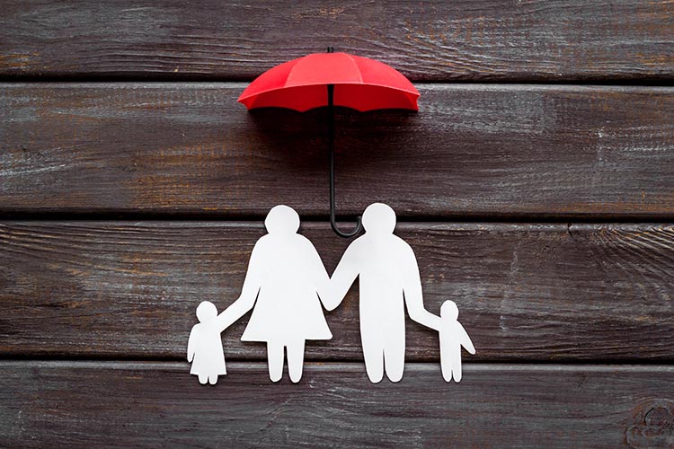 Health insurance concept. Family cutout under umbrella - O'Fallon, IL